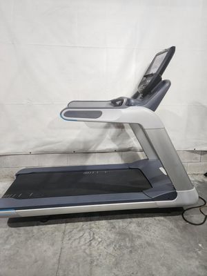 A treadmill is sitting on top of a concrete floor.