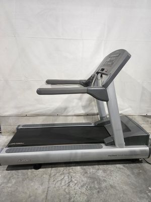 A treadmill is sitting on top of a concrete floor.