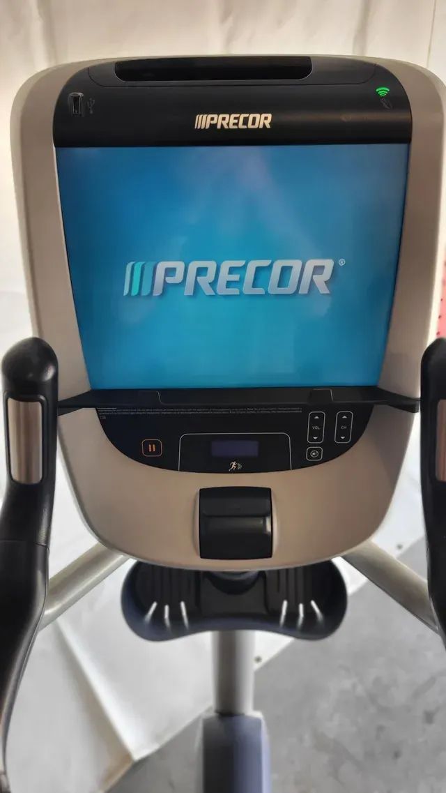 The front of a precor elliptical machine with a blue screen.