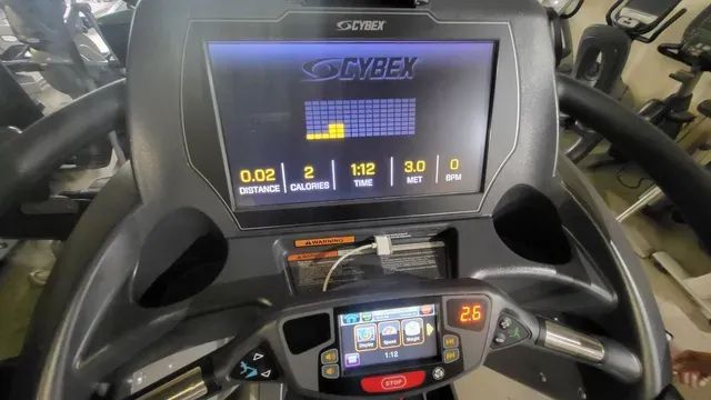 A treadmill with a screen that says cybex on it