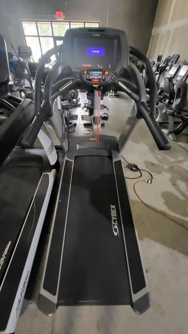 A treadmill is sitting in a gym.