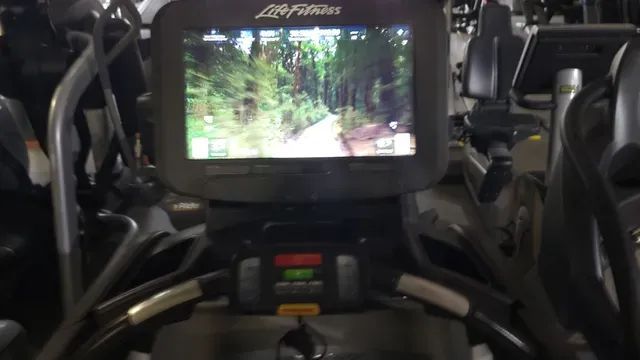 An elliptical machine with a screen that says life fitness on it