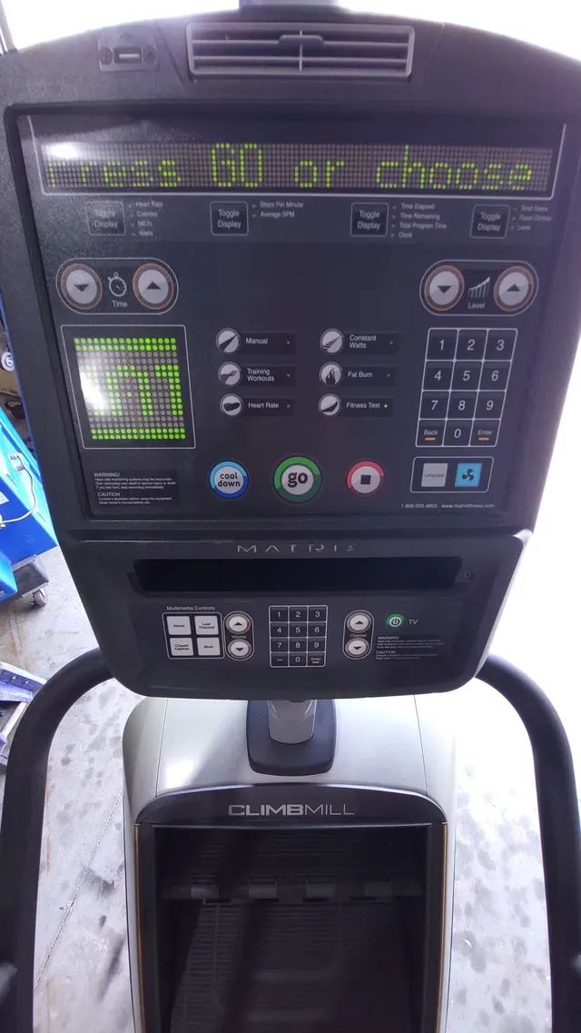 A close up of a stair climber with a control panel.