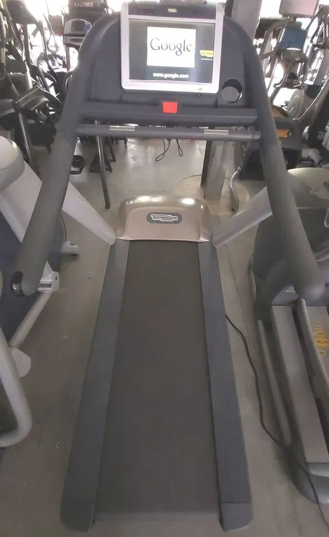 A treadmill with a screen that says google on it