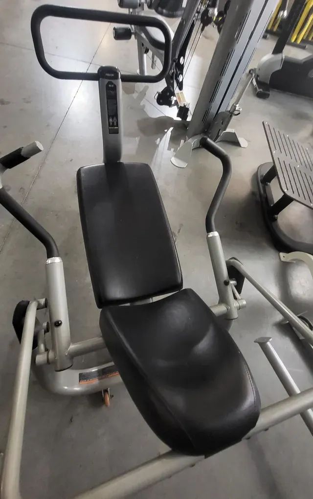 A black and white exercise machine is sitting in a gym.