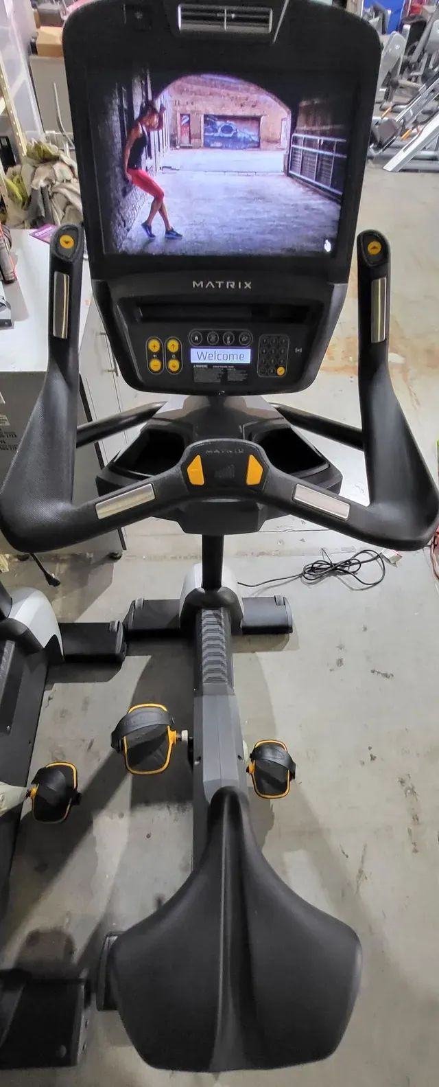A black exercise bike with a monitor on top of it.
