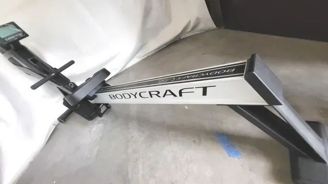 A bodycraft exercise machine is sitting on a concrete floor.