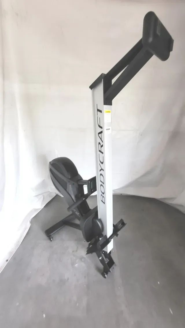 A buddy trap rowing machine is sitting on a table.