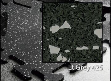 A black and white photo of a piece of rubber flooring.