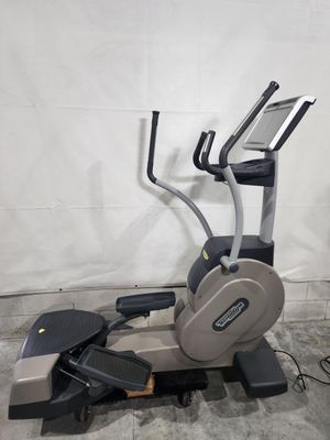 An elliptical machine is sitting on a concrete floor.