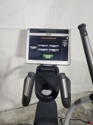 A treadmill with a monitor on top of it.