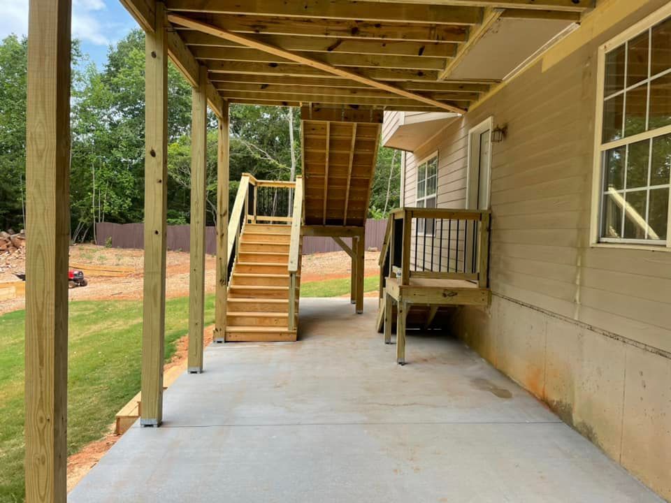 There is a wooden deck with stairs leading up to it.