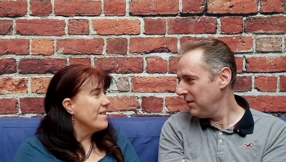 Mark & Fiona Gilpin speaking on a sofa.