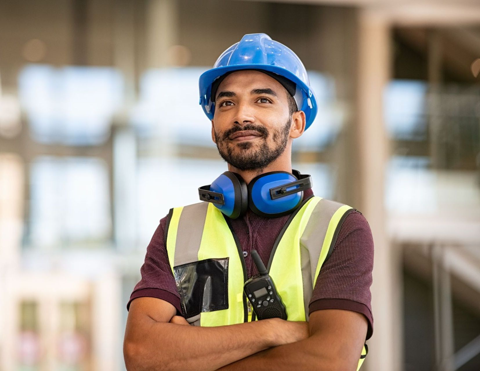 young male construction worker wearing blue hard hat