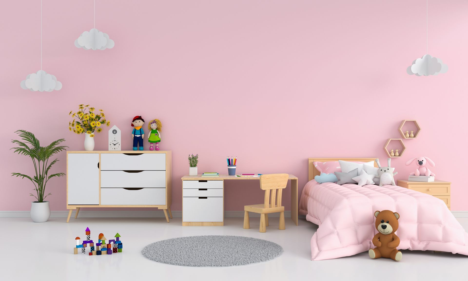 Cameretta per bambini con pareti rosa, letto, scrivania, cassettiera, piante, giocattoli e un soffice tappeto grigio.