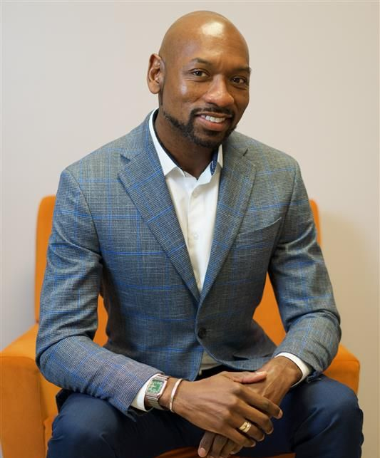 Two people holding hands, offering comfort or support.