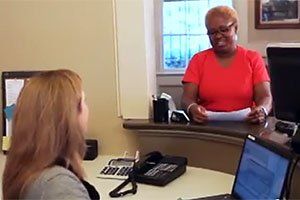 Photo of woman at front desk in office