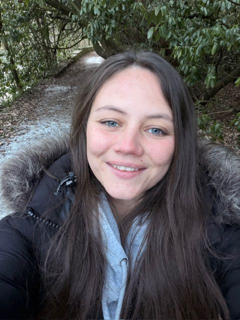Woman standing in garden smiling