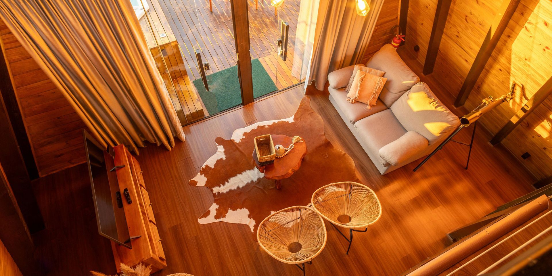An aerial view of a living room with a couch and two chairs.