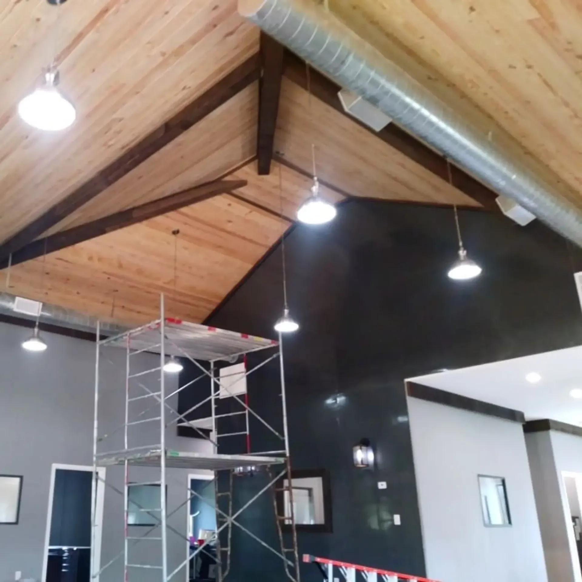 Panther City Electric LLC - A room with a wooden ceiling and a ladder