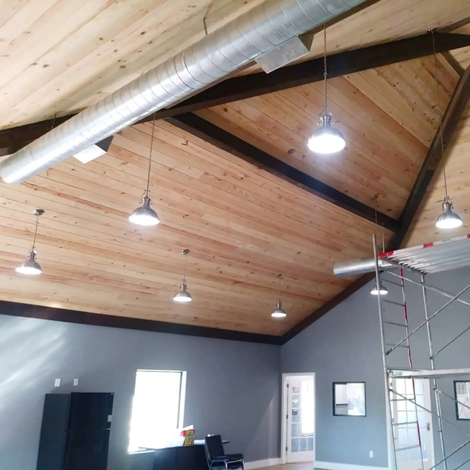 Panther City Electric LLC - A room with a wooden ceiling and a ladder