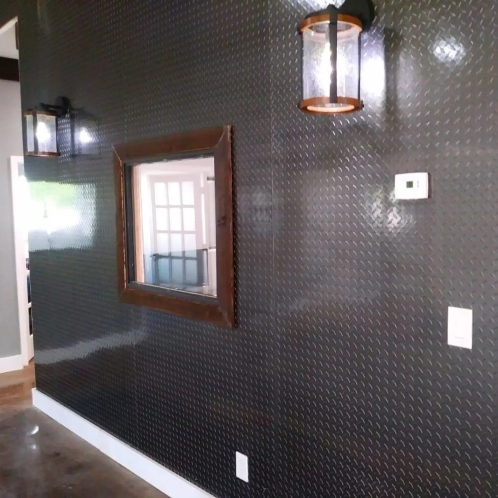 Panther City Electric LLC - A black wall with a mirror and lanterns on it