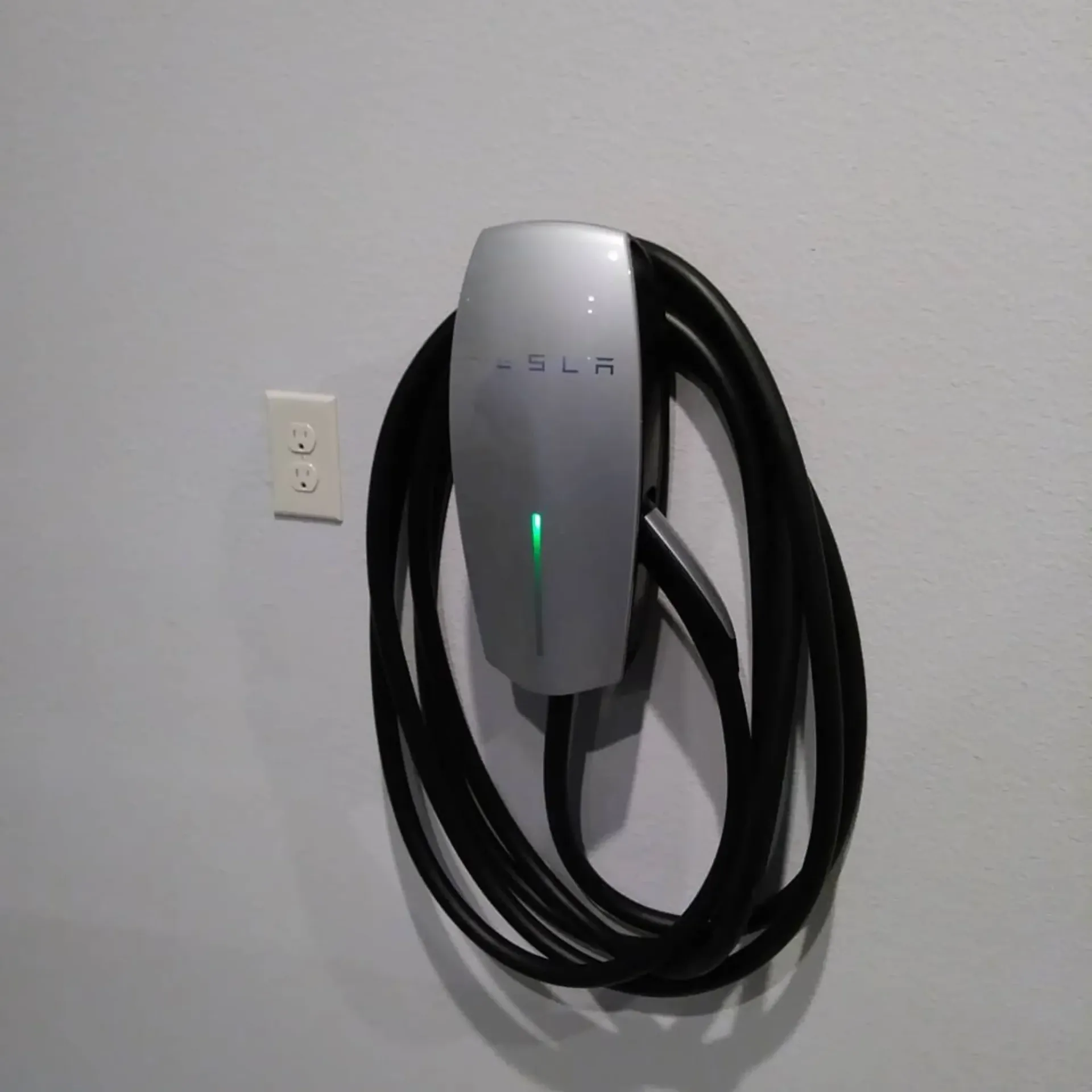 Panther City Electric LLC - A tesla charging station is attached to a wall