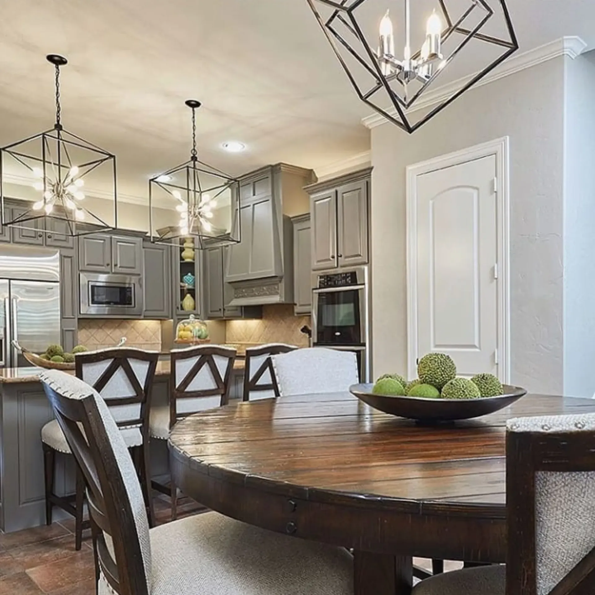 Panther City Electric LLC - A kitchen with a wooden table and chairs and a bowl of apples on it