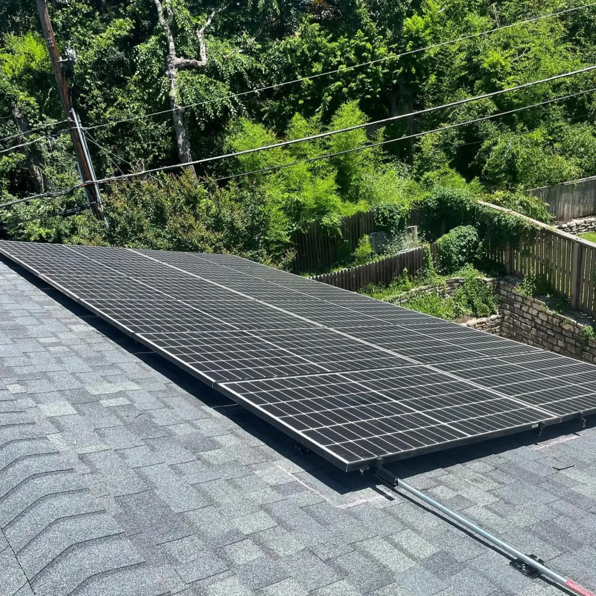Panther City Electric LLC - A row of solar panels are sitting on top of a roof.