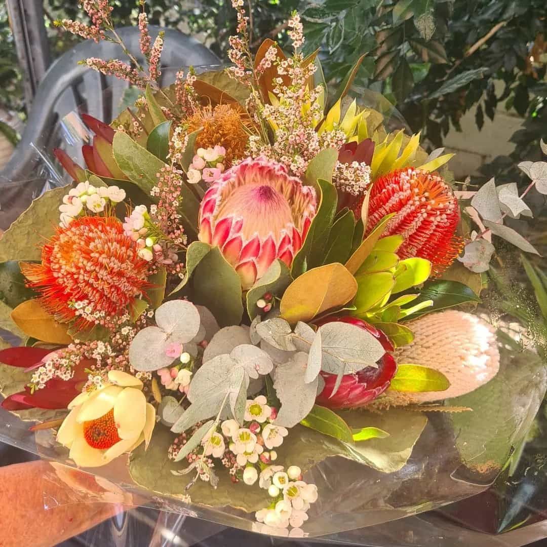 A Person Is Holding A Bouquet Of Flowers — The House of Flowers In Kirwan, QLD