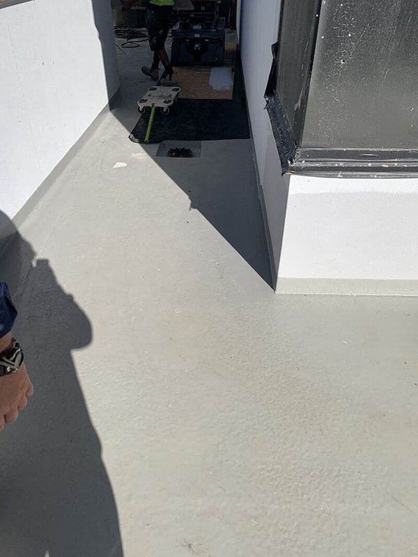A Set Of Stairs Leading Up To A Balcony Overlooking The Ocean — Eldred Waterproofing In Whitfield, QLD