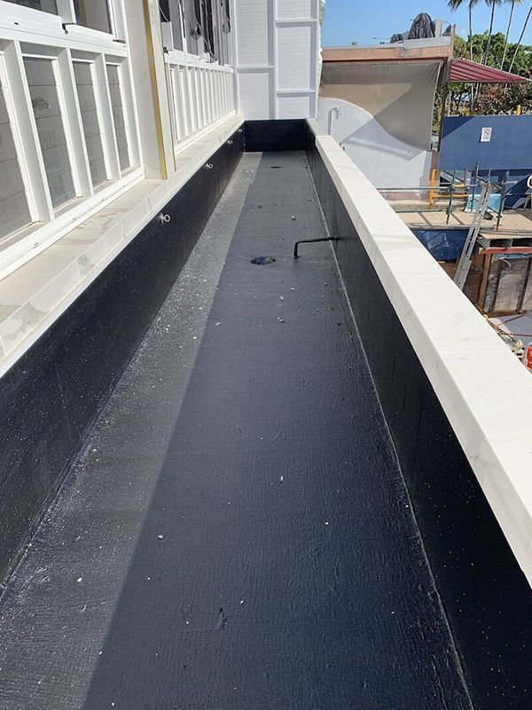 A Very Long Black Drain On The Side Of A Building — Eldred Waterproofing In Whitfield, QLD