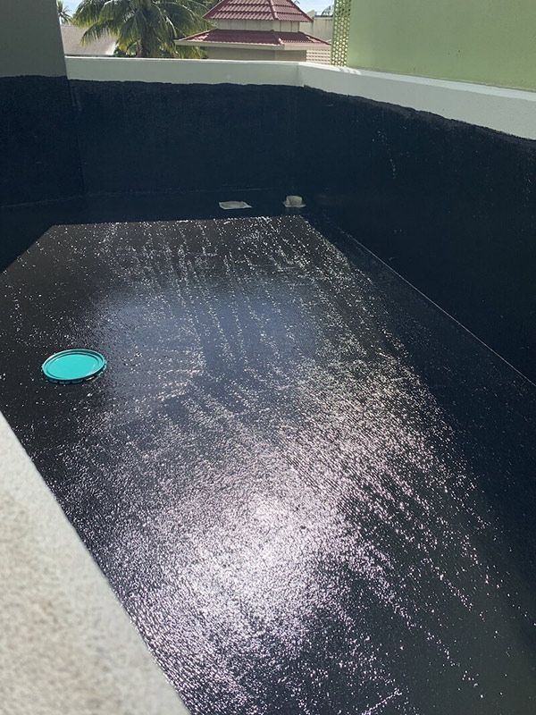 A Black Swimming Pool Is Being Built On A Balcony With A Green Drain — Eldred Waterproofing In Whitfield, QLD