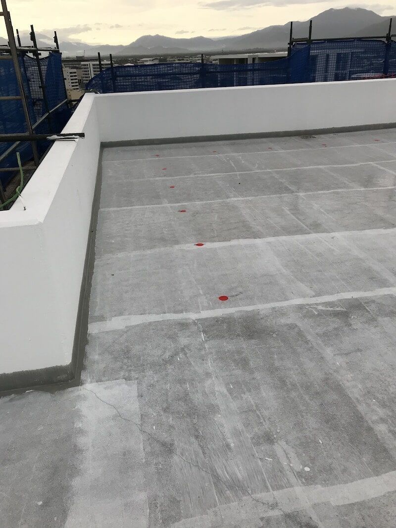A Rooftop With A Concrete Floor And A White Wall — Eldred Waterproofing In Whitfield, QLD