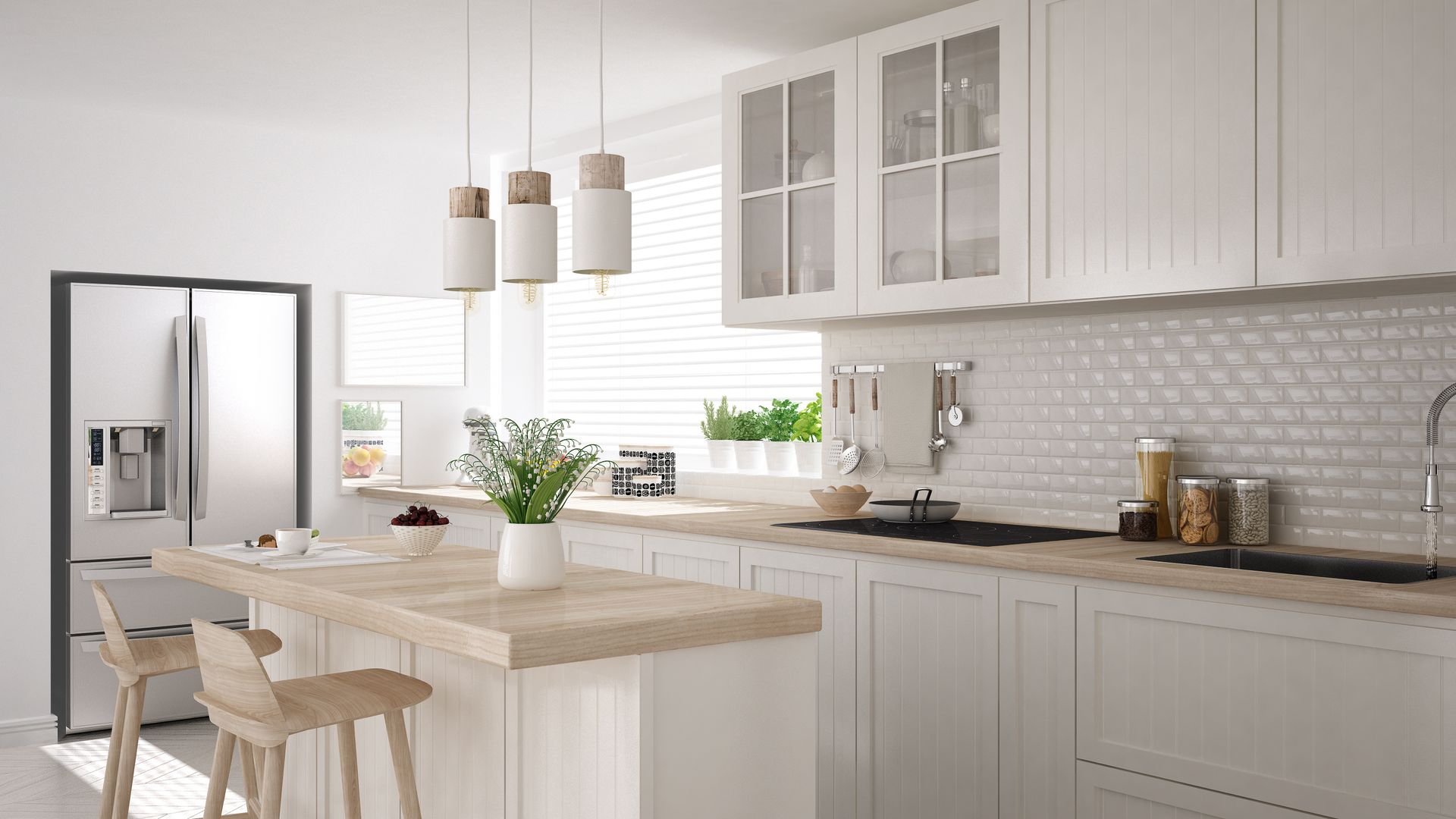 A bright, modern kitchen featuring white cabinets, a light wood island with two stools, and a stainless steel refrigerator.