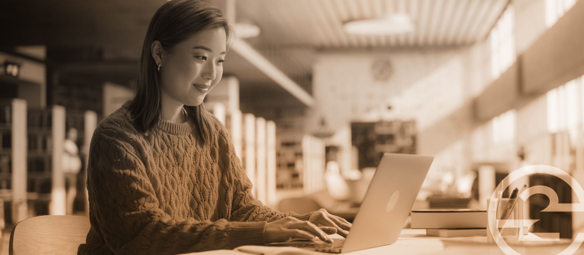Person completing a certification on a laptop in a warm-lit library