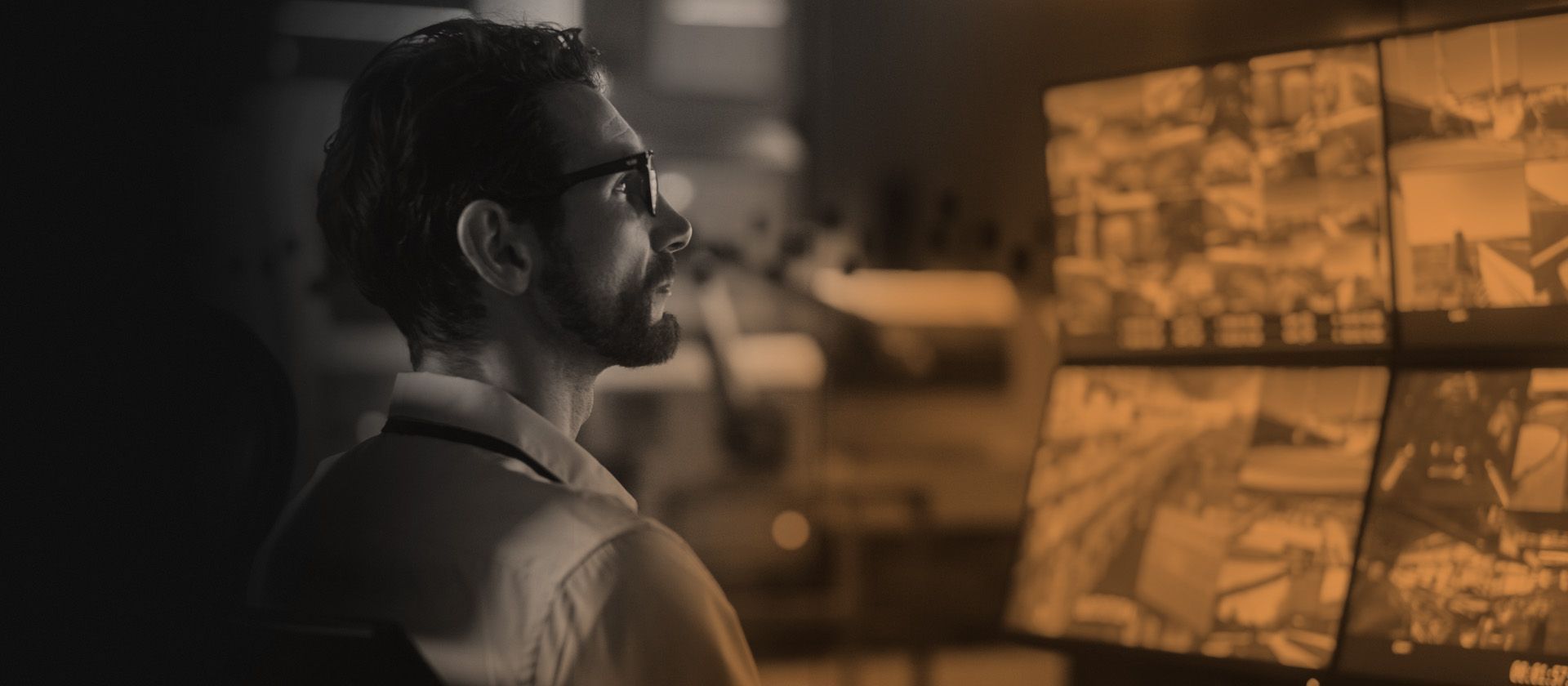 Man looking at multiple computer screens