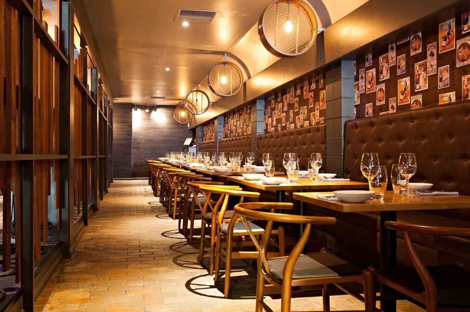 A Long Hallway With Tables And Chairs In A Restaurant — BOLD Architecture + Interior Design In Mackay, QLD
