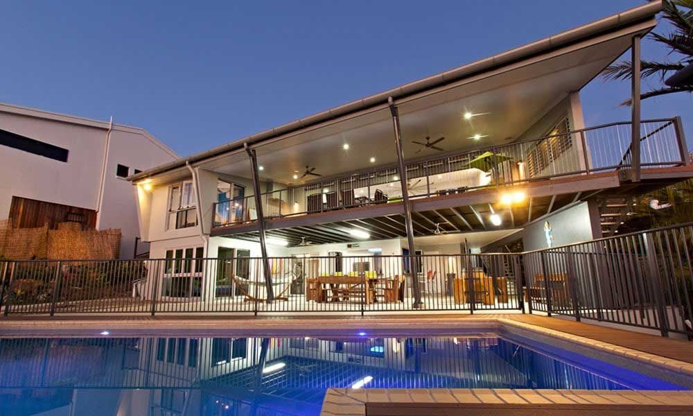 A Large House With A Swimming Pool In Front Of It — BOLD Architecture + Interior Design In Mackay, QLD