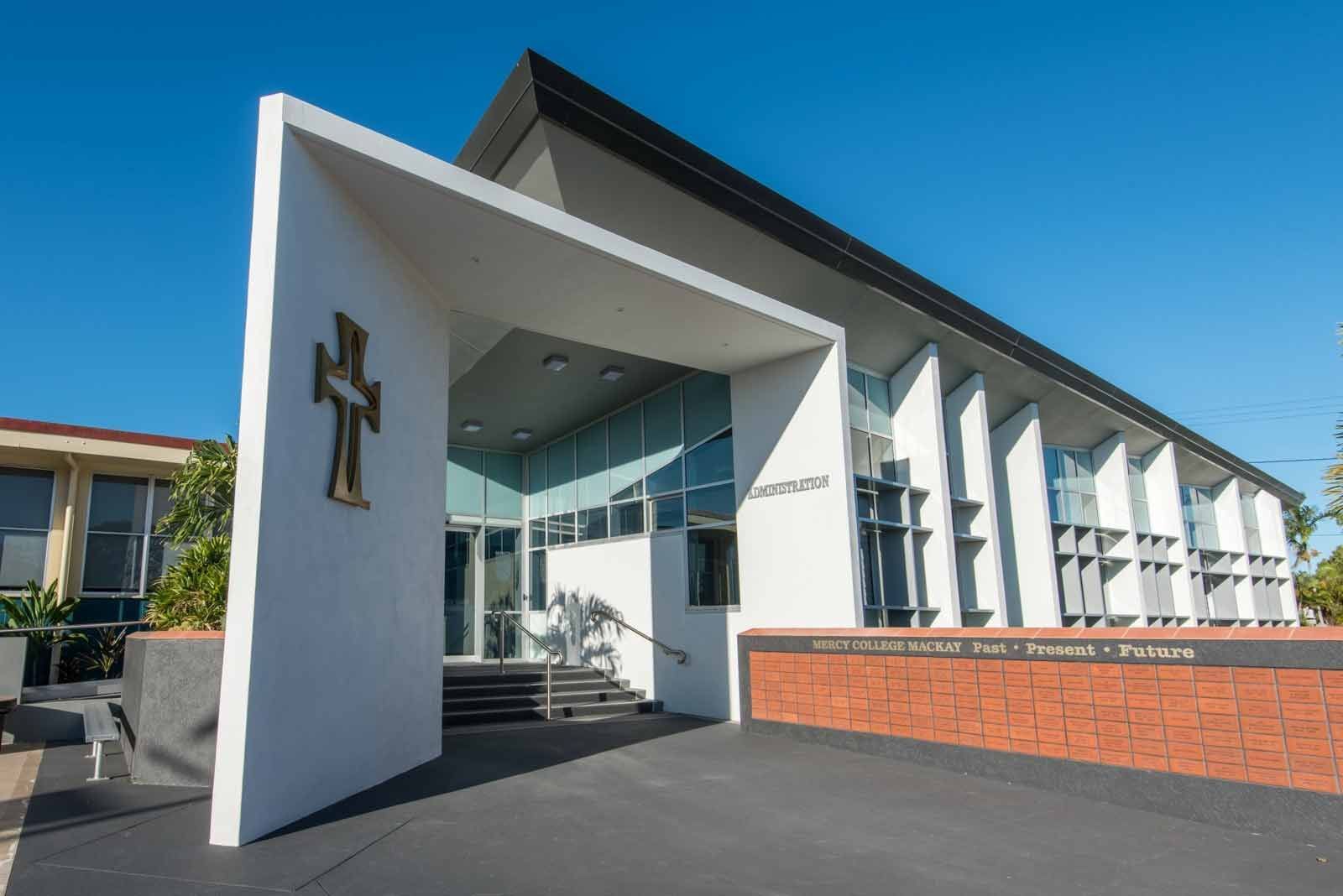 A Large White Building With A Cross On The Side Of It — BOLD Architecture + Interior Design In Mackay, QLD