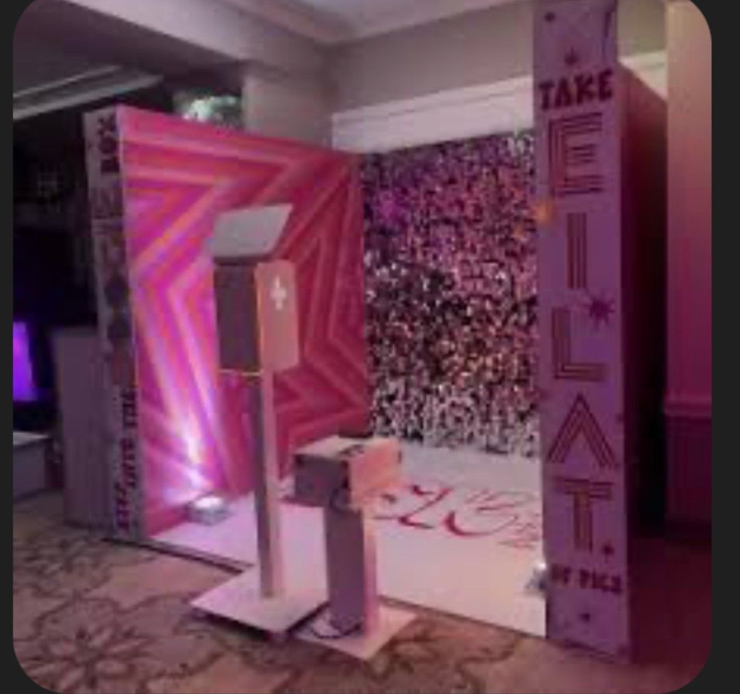 Photo booth with pink star backdrop and 