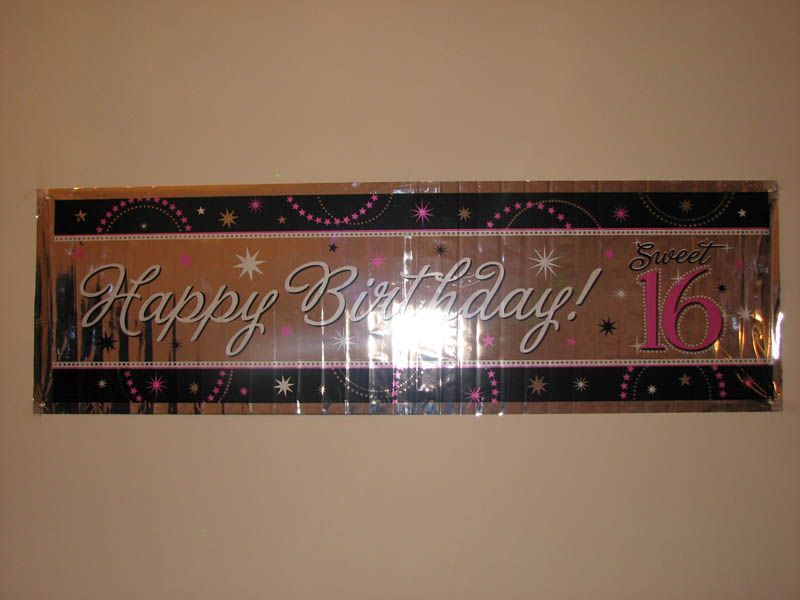 Banner with “Happy Birthday! Sweet 16” in pink, black, and gold.