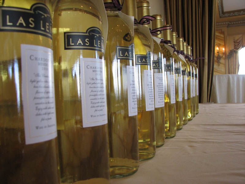 Bottles of white wine lined up on a table, label detail showing 