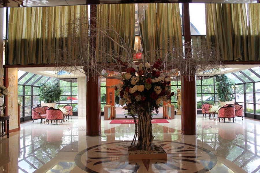 Elegant lobby with floral arrangement, seating areas, and large windows.