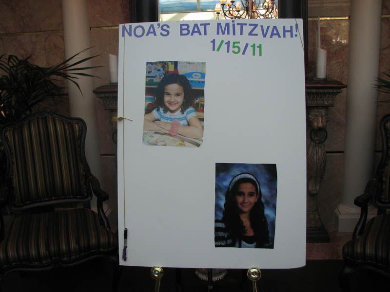 A sign for Noa's Bat Mitzvah. Includes two photos of Noa, event title, and date.