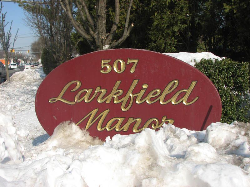 Red oval sign with gold lettering: 