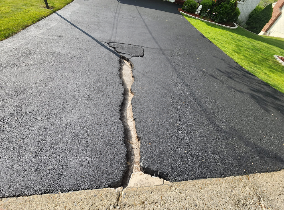 driveway before sealcoating repair with huge crack down the middle