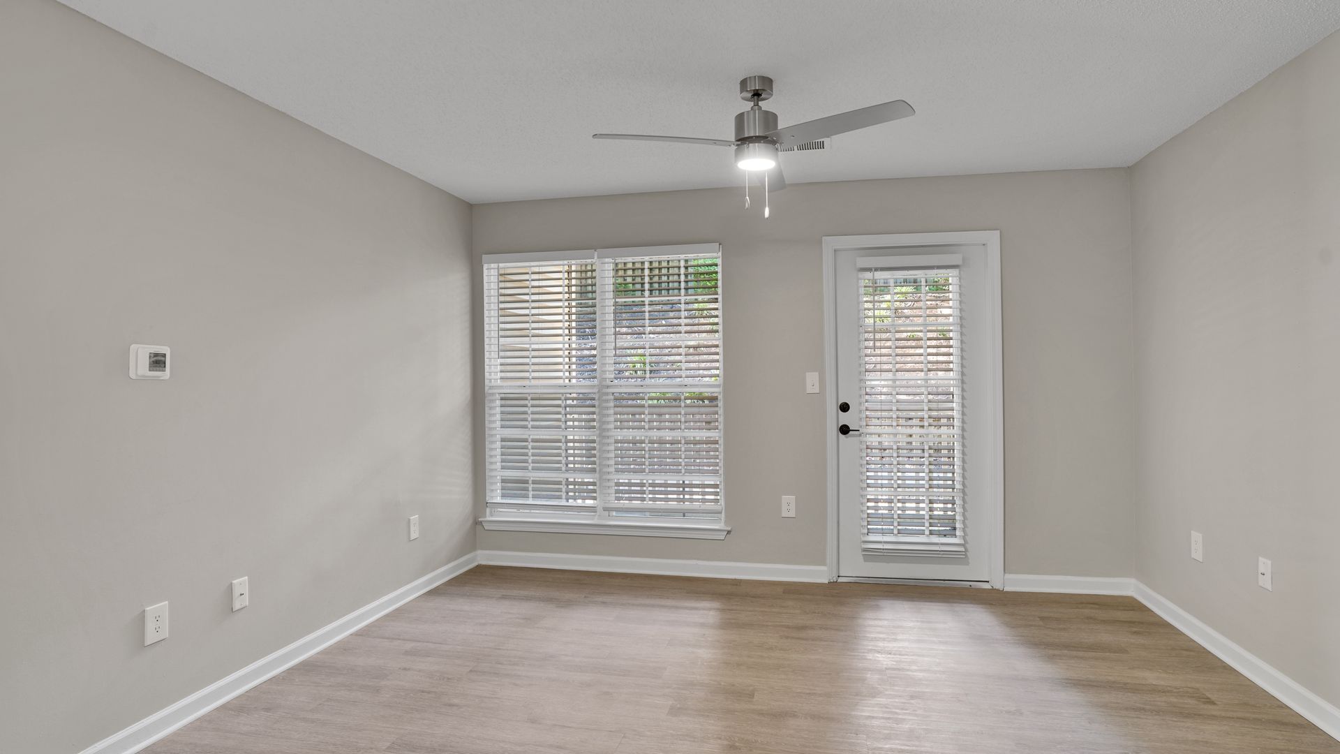 Living room with couch, TV, dining table, and open kitchen.