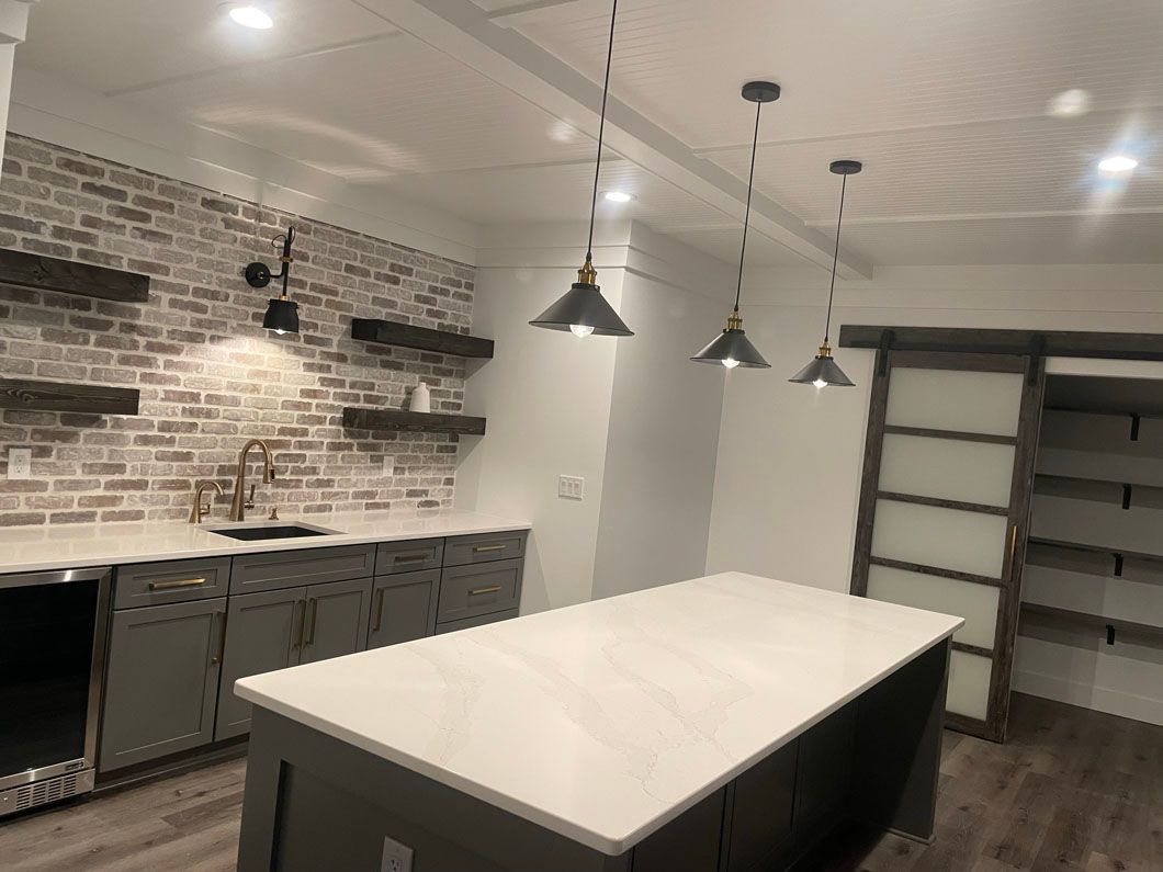 There is a large island in the middle of the kitchen.