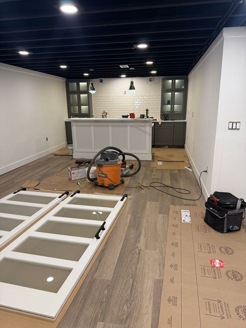 A vacuum cleaner is sitting on the floor in a room.